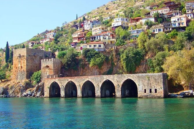 Alanya Pirate Boat Trip with Lunch & Free Soft Drinks - Coastal sights before the swim: shipyard, Red Tower, and cave country