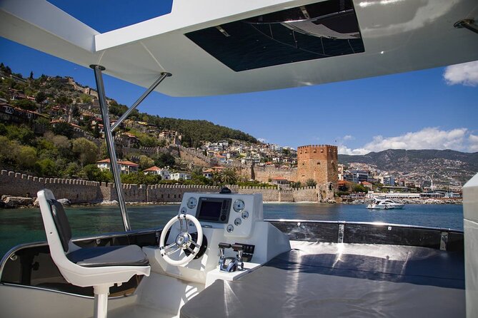 Alanya Private Yacht Tour with Lunch, Soft Beverage & Transfer - Stop 1: Alanya Kalesi hour on deck with a castle backdrop