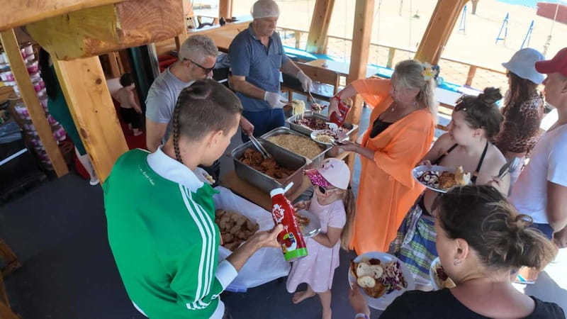 Side: Dolphin Boat Tour With Lunch Foam party Swimming - Lunch by the water: grilled chicken, salad, and rice